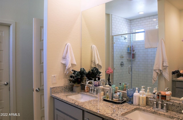 bathroom featuring vanity and a shower with shower door