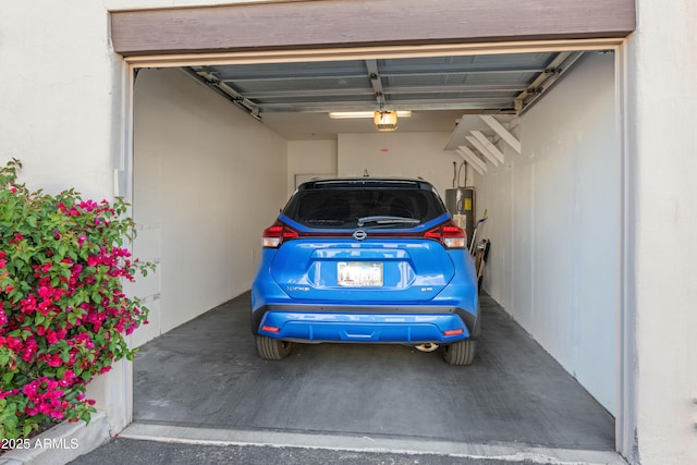 garage with a garage door opener and electric water heater