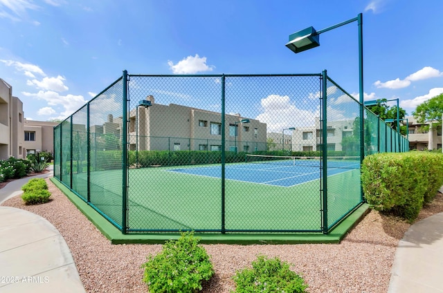 view of sport court featuring a residential view and fence