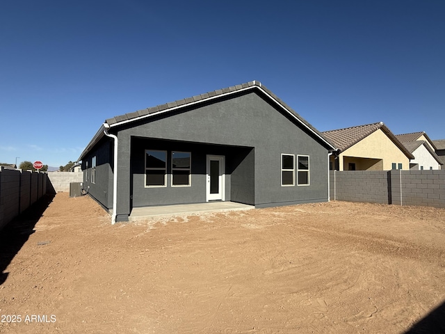 back of house featuring central AC