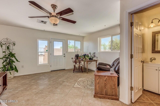28648 N 165th Ave, Surprise, AZ 85387 - foyer entrance with ceiling fan, light tile patterned flooring, and baseboards