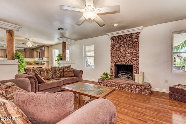 28648 N 165th Ave, Surprise, AZ 85387 - living area with a ceiling fan, baseboards, wood finished floors, a stone fireplace, and recessed lighting