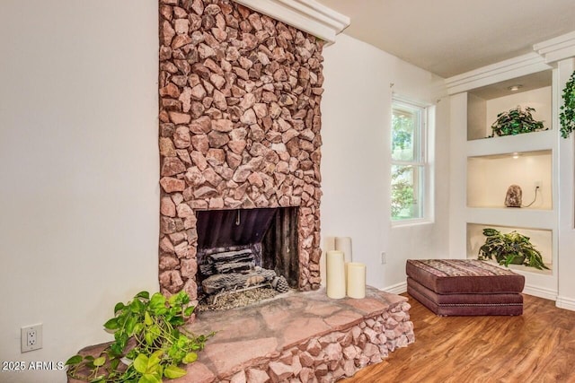 28648 N 165th Ave, Surprise, AZ 85387 - living area featuring wood finished floors, a stone fireplace, and baseboards