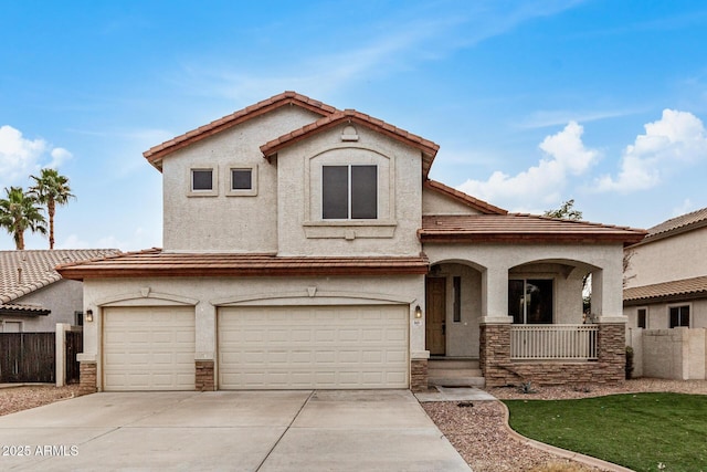 mediterranean / spanish home with stucco siding, a porch, an attached garage, fence, and driveway