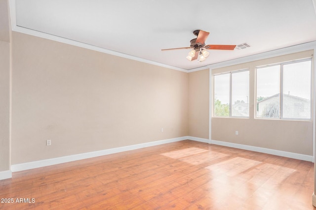 empty room with light wood-type flooring, ceiling fan, and ornamental molding