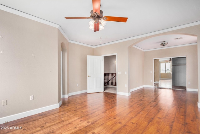 spare room with ornamental molding, hardwood / wood-style floors, and ceiling fan