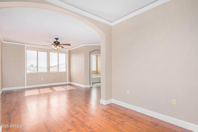 unfurnished room with ornamental molding, hardwood / wood-style floors, and ceiling fan