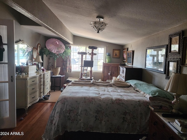 bedroom featuring a textured ceiling, vaulted ceiling, and hardwood / wood-style flooring