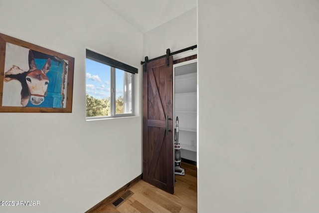 interior space featuring a barn door and light hardwood / wood-style floors