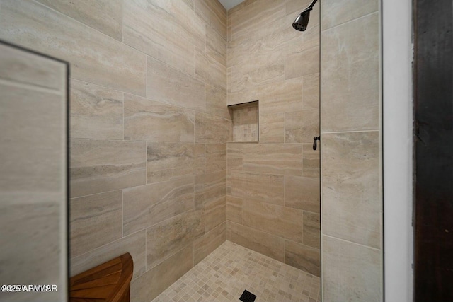 bathroom with tiled shower