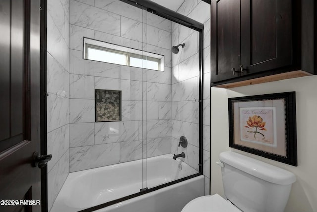 bathroom with shower / bath combination with glass door and toilet