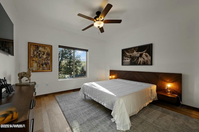 bedroom featuring ceiling fan and dark hardwood / wood-style flooring