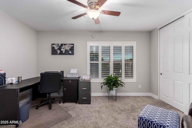 office space featuring carpet, baseboards, and ceiling fan