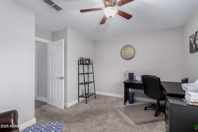 office area featuring carpet flooring, baseboards, visible vents, and a ceiling fan