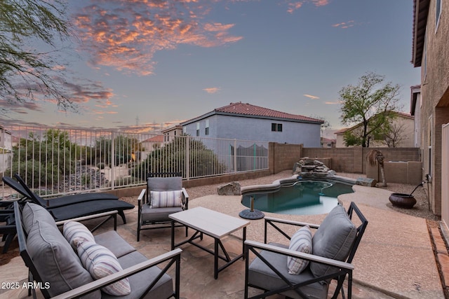 pool at dusk featuring a patio area, a fenced in pool, a fenced backyard, and an outdoor hangout area