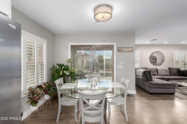 dining room featuring a wealth of natural light, visible vents, recessed lighting, and wood finished floors