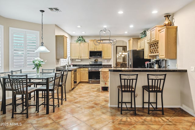 2758 N Sterling, Mesa, AZ 85207 - kitchen featuring appliances with stainless steel finishes, a peninsula, light brown cabinets, a chandelier, and a breakfast bar area