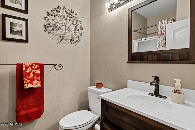 2758 N Sterling, Mesa, AZ 85207 - full bathroom featuring toilet, vanity, a textured wall, and a shower