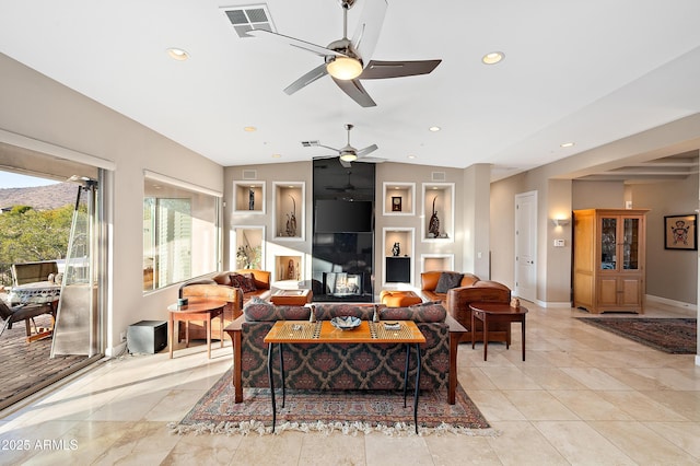 living room with vaulted ceiling and a fireplace