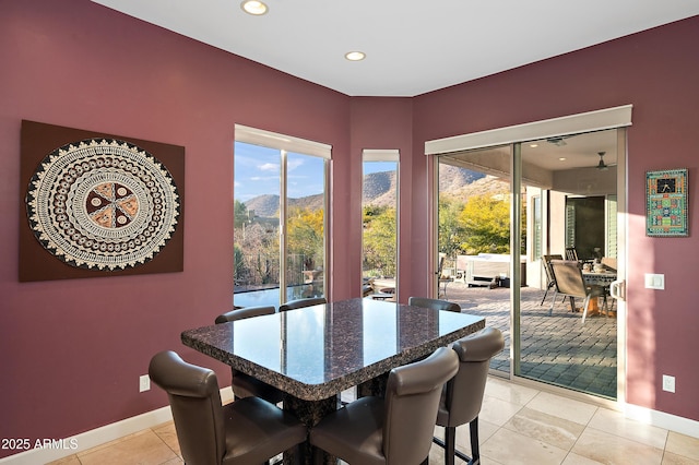 dining space featuring a mountain view and light tile patterned floors