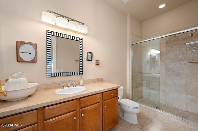 bathroom featuring vanity, toilet, an enclosed shower, and tile patterned flooring