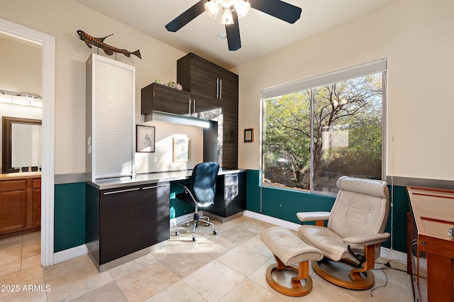 office area with light tile patterned floors, sink, and ceiling fan