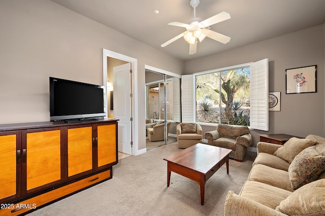 living room with light colored carpet and ceiling fan