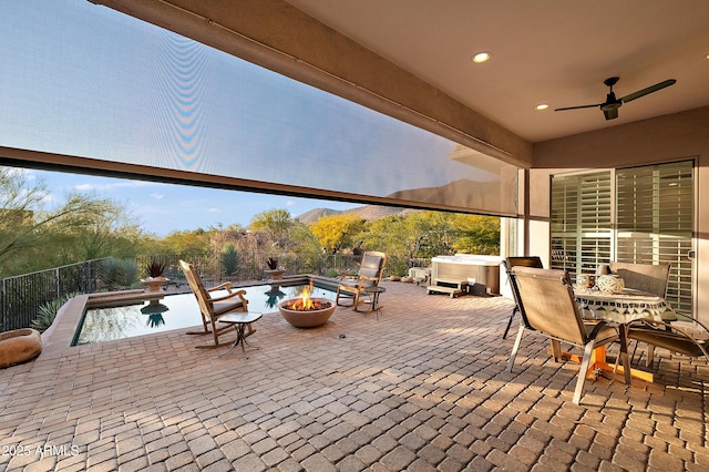 view of patio featuring a pool with hot tub and ceiling fan