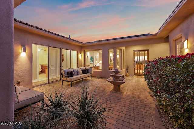 patio terrace at dusk with an outdoor living space