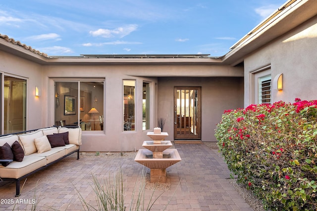 property entrance with a patio and outdoor lounge area