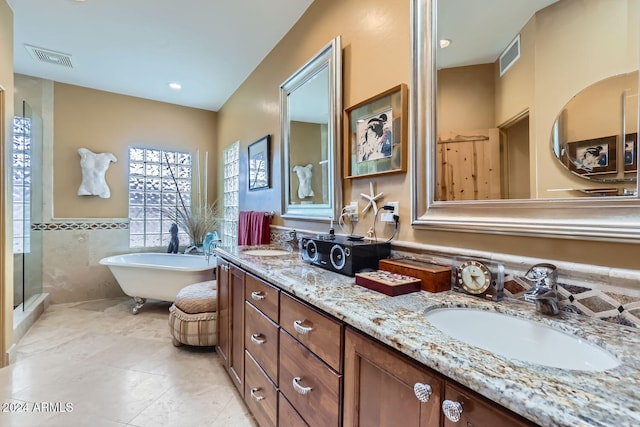 bathroom with tile patterned floors, vanity, independent shower and bath, and tile walls