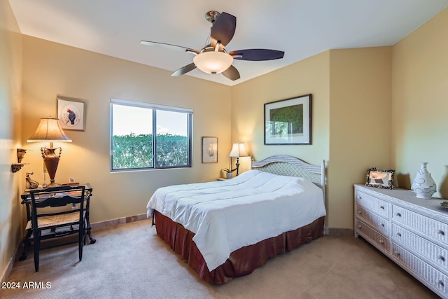 bedroom featuring ceiling fan and light carpet