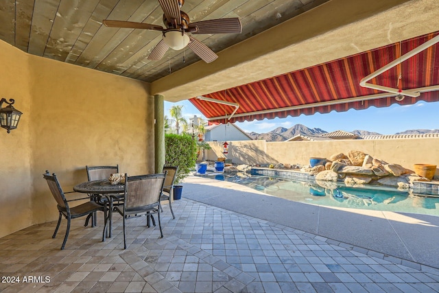 view of patio / terrace featuring a mountain view and ceiling fan