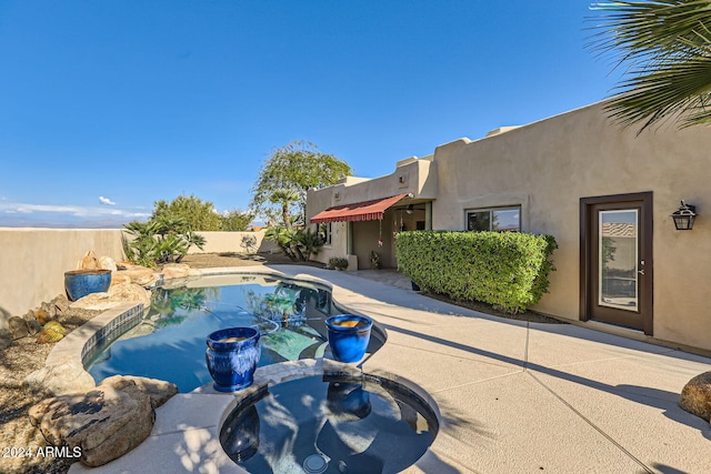 view of swimming pool with a patio area and an in ground hot tub