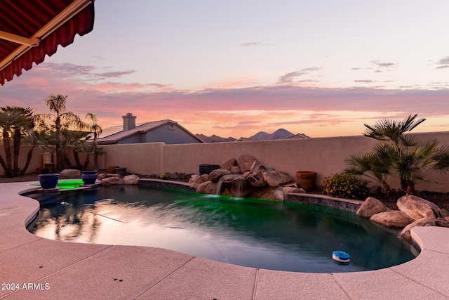 view of pool at dusk