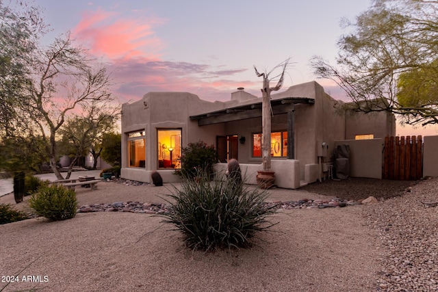 back house at dusk with a patio