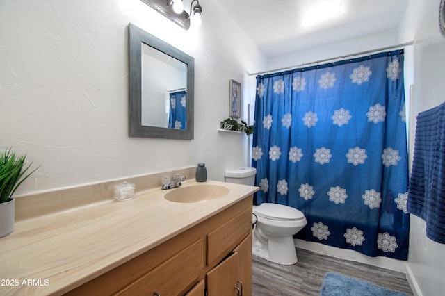 706 E Roosevelt Ave, Buckeye, AZ 85326 - full bathroom with vanity, wood finished floors, toilet, and curtained shower