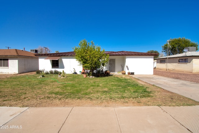 706 E Roosevelt Ave, Buckeye, AZ 85326 - view of front of home with a front yard, metal roof, a standing seam roof, and concrete driveway