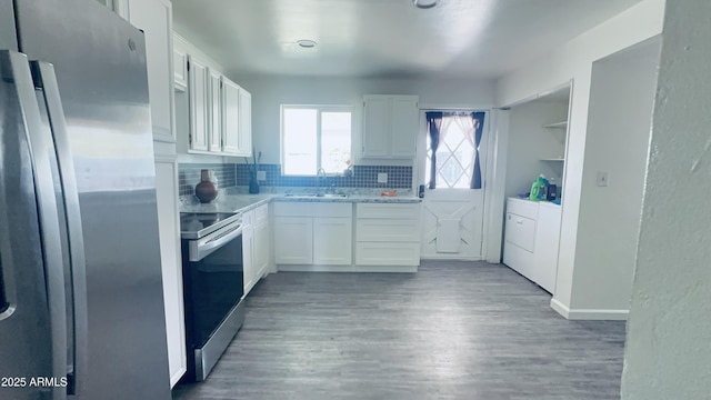706 E Roosevelt Ave, Buckeye, AZ 85326 - kitchen featuring stainless steel appliances, washing machine and dryer, and white cabinets