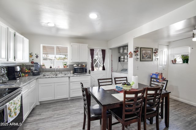 706 E Roosevelt Ave, Buckeye, AZ 85326 - dining space featuring washer / clothes dryer and light wood-style flooring