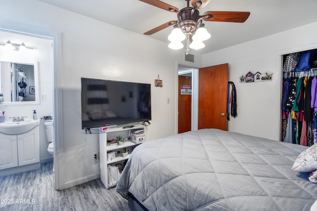 706 E Roosevelt Ave, Buckeye, AZ 85326 - bedroom with wood finished floors, a closet, a sink, ensuite bath, and ceiling fan