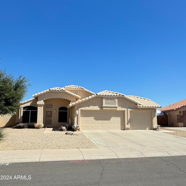 mediterranean / spanish-style home with a garage