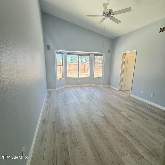 unfurnished room featuring high vaulted ceiling, ceiling fan, and light hardwood / wood-style flooring