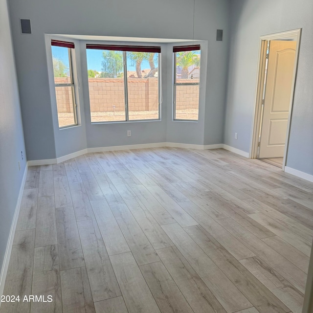 spare room with light hardwood / wood-style flooring