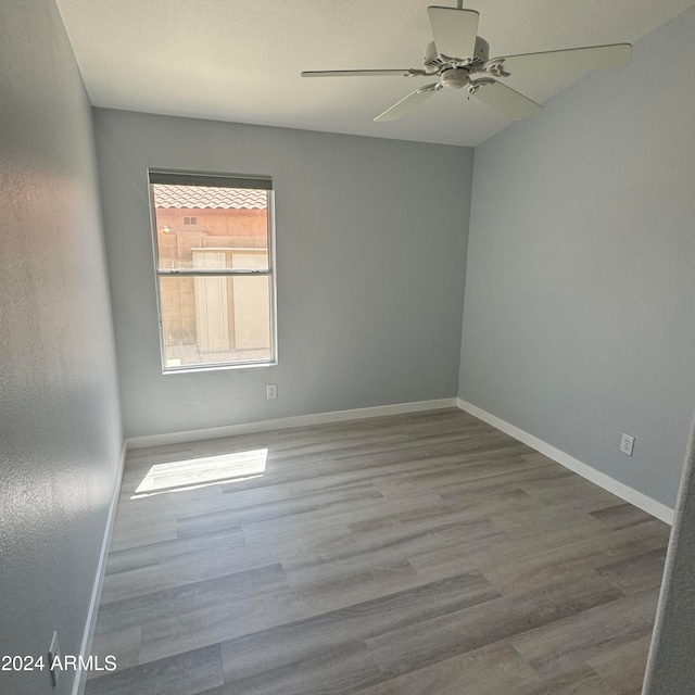 empty room featuring ceiling fan and hardwood / wood-style flooring