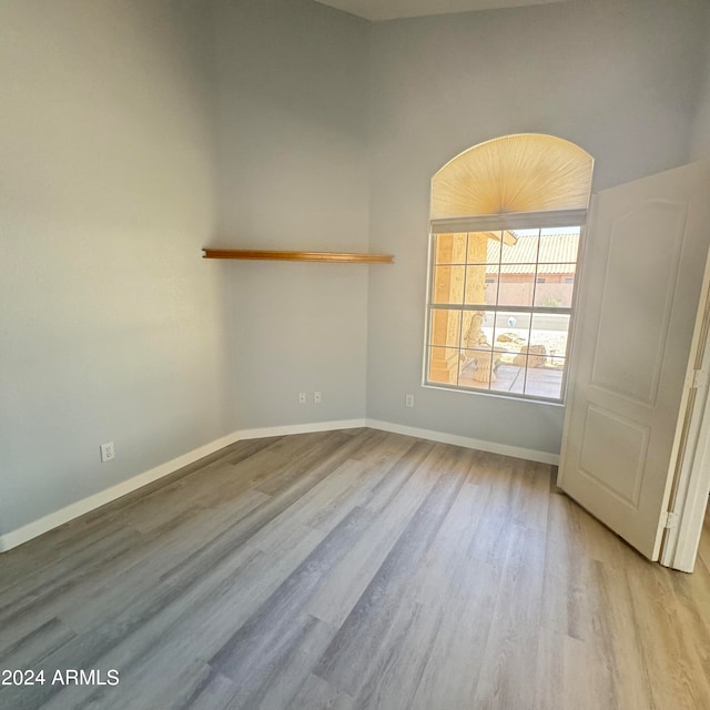 unfurnished room with light wood-type flooring