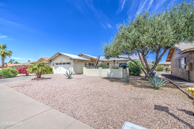 single story home featuring an attached garage, fence, and driveway