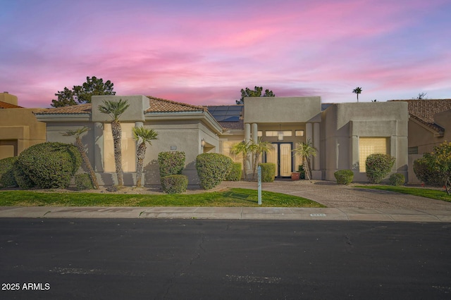 view of front of property with solar panels