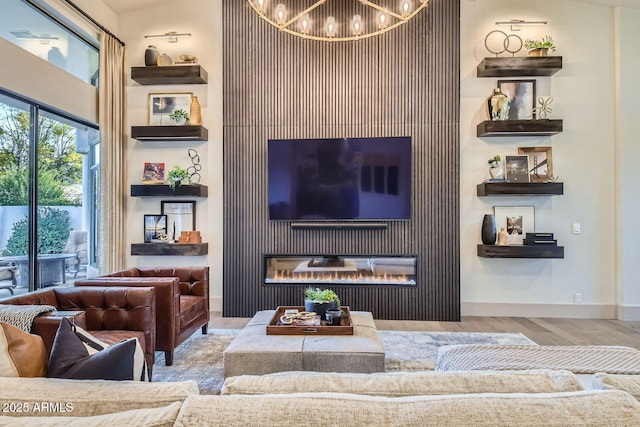 living room featuring an inviting chandelier and light hardwood / wood-style flooring