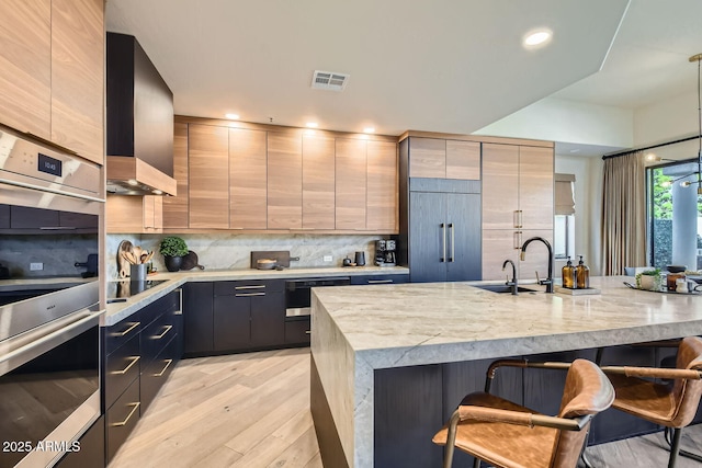 kitchen featuring a kitchen bar, sink, decorative light fixtures, black electric cooktop, and backsplash